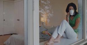 Relaxed woman drinking tea in her bedroom window