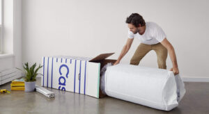 man unboxing a casper mattress
