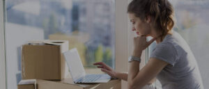 woman reading moving checklist on laptop