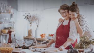 holiday background with two family members baking together