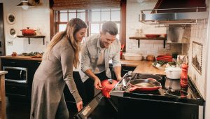 Happy couple cooking in warm and cozy kitchen