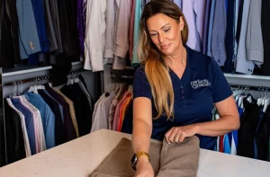 Professional organizer and Perfectly Placed team member folding clothes in a closet