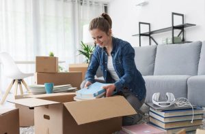 Woman providing unpacking services in St. Louis organizing a room after a move