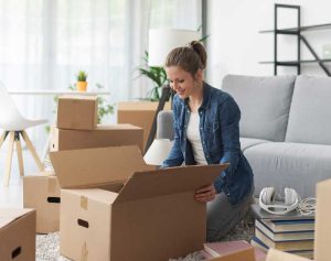 Woman unpacking boxes for home unpacking company