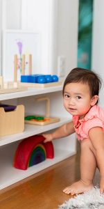 Toddler playing in an organized and decluttered playroom