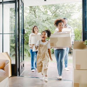Family walking into new home getting unpacked by home organizing service