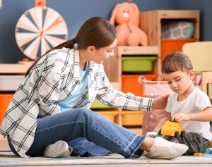 Mother playing with son in organized bedroom