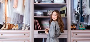 Woman standing in beautifully organized and designed closet