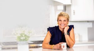 Susan Stewart sitting at clean, organized kitchen counter