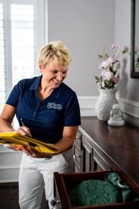 St. Louis and West County Home organization expert Susan Stewart looking at a dresser drawer