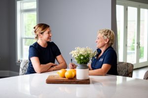 St. Louis-based decluttering services professional Susan Stewart talking with a client in a kitchn