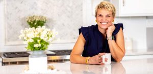 Expert home organizer Susan Stewart sitting in a clean, beautiful kitchen