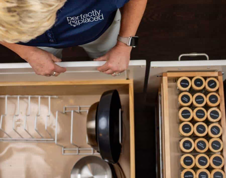 Experienced home organizer working in a kitchen drawer